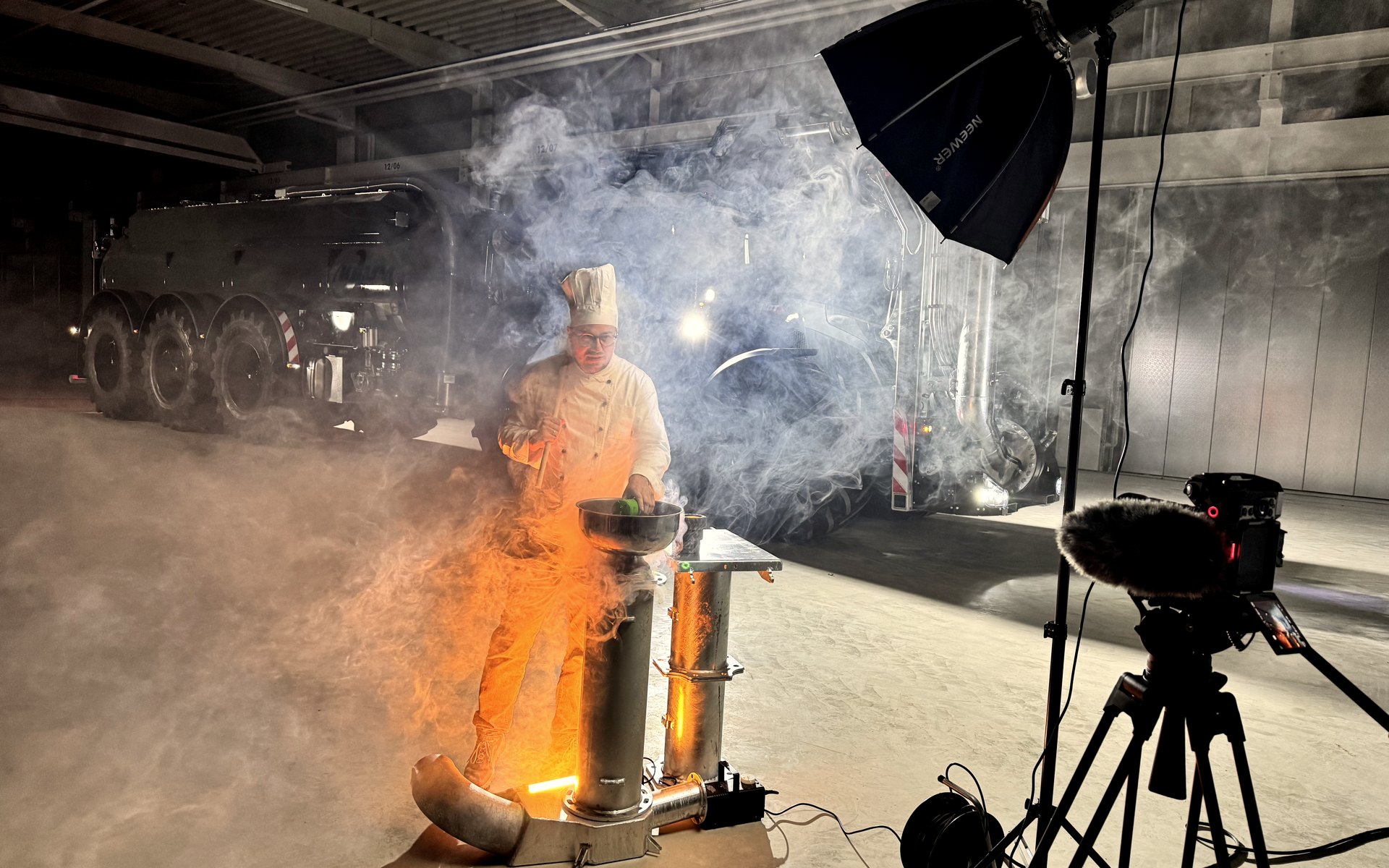 Nachtdreh in einer Halle: Softbox, Kamera auf Stativ und ein Kommunalfahrzeug im Nebel